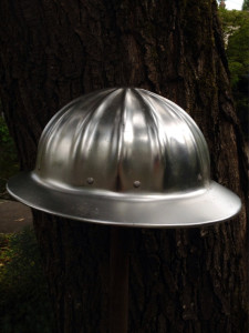 Aluminum Hard Hat and Tree Trunk