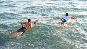 Surfers paddling